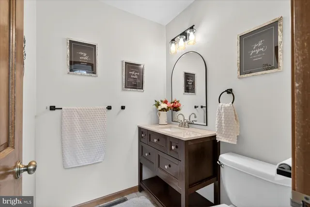 a bathroom with a sink cabinets and a wooden floor