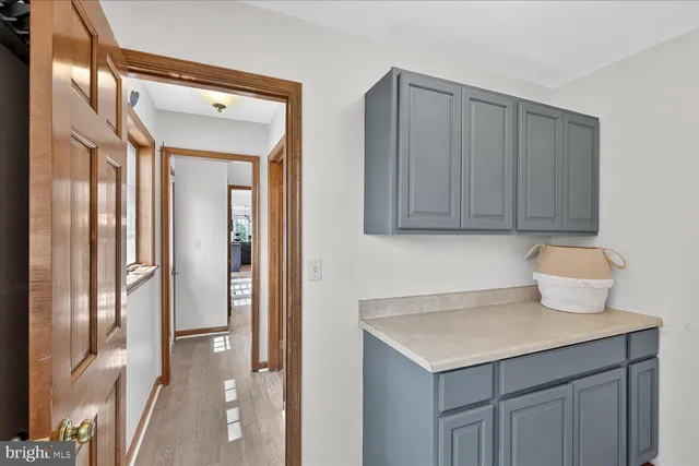 a view of staircase with railing and a chandelier