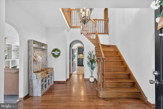 a view of a hallway with wooden floor and entryway