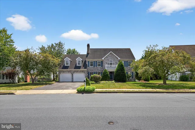 an aerial view of a house with a garden and a yard