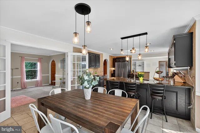 a kitchen with stainless steel appliances kitchen island granite countertop a stove and cabinets