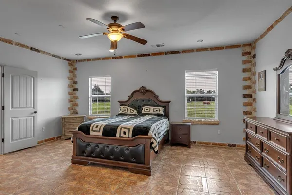 a bedroom with bed and a window