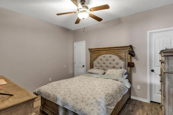 a bedroom with a bed and a chandelier