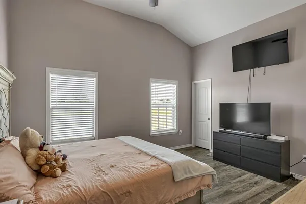 a bedroom with a bed and a flat screen tv