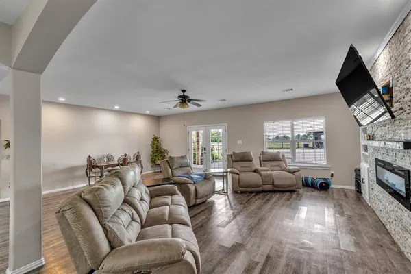 a living room with furniture fireplace and a flat screen tv