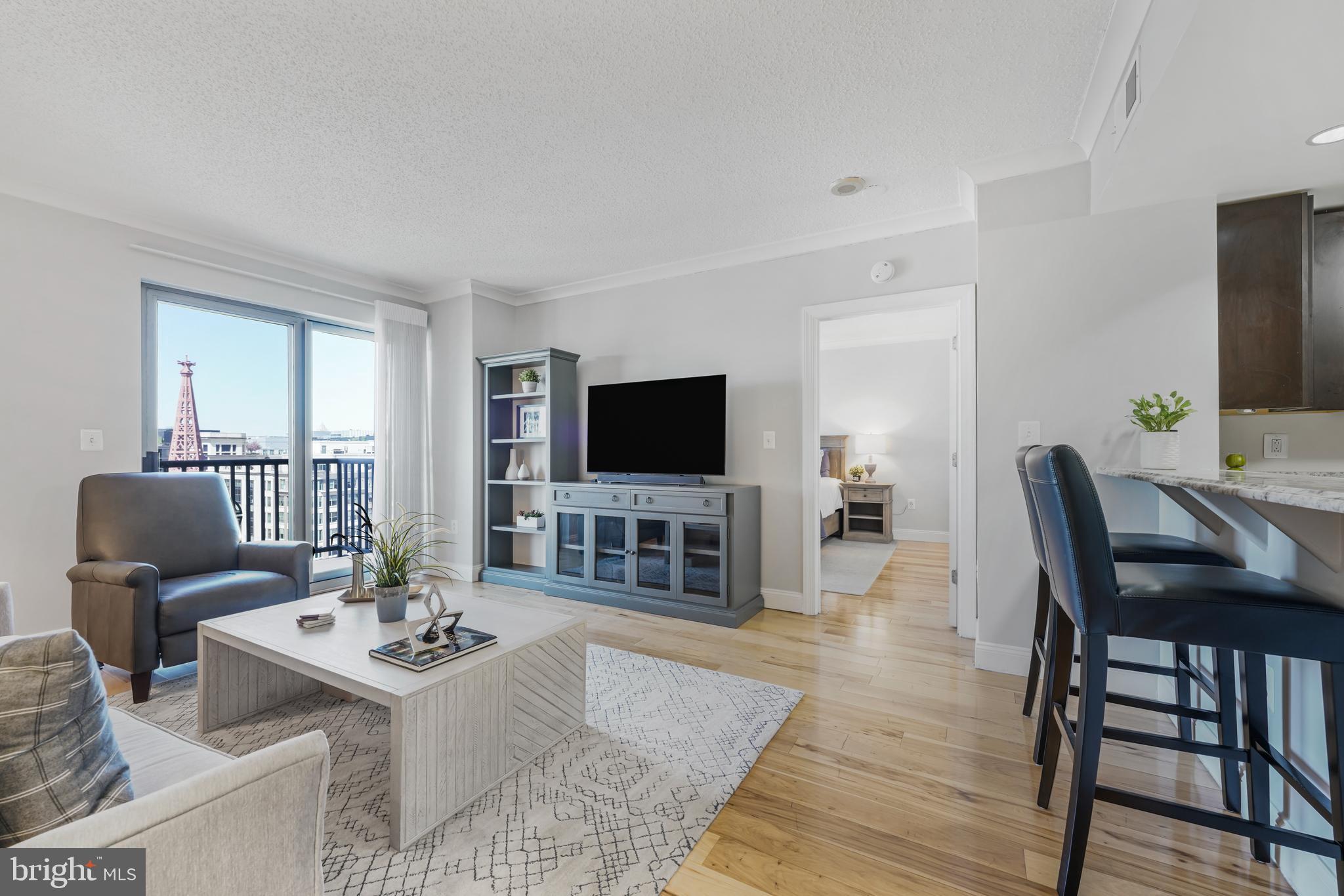 777 7th Street Northwest, Unit 1124 Washington, DC 20001 - Photo 5 of 16 a living room with furniture and a flat screen tv