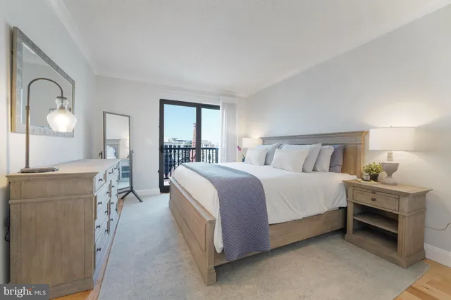 a spacious bedroom with a bed and a dresser in it