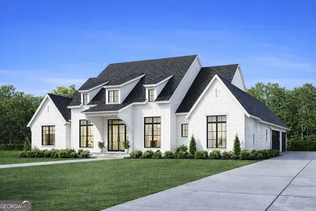 a front view of a house with a garden