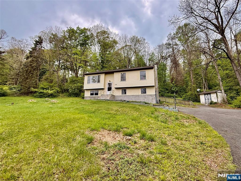 154 Cork Hill Road Franklin, NJ 07416 - Photo 25 of 35 a view of a white house with a large tree with yard and sitting space