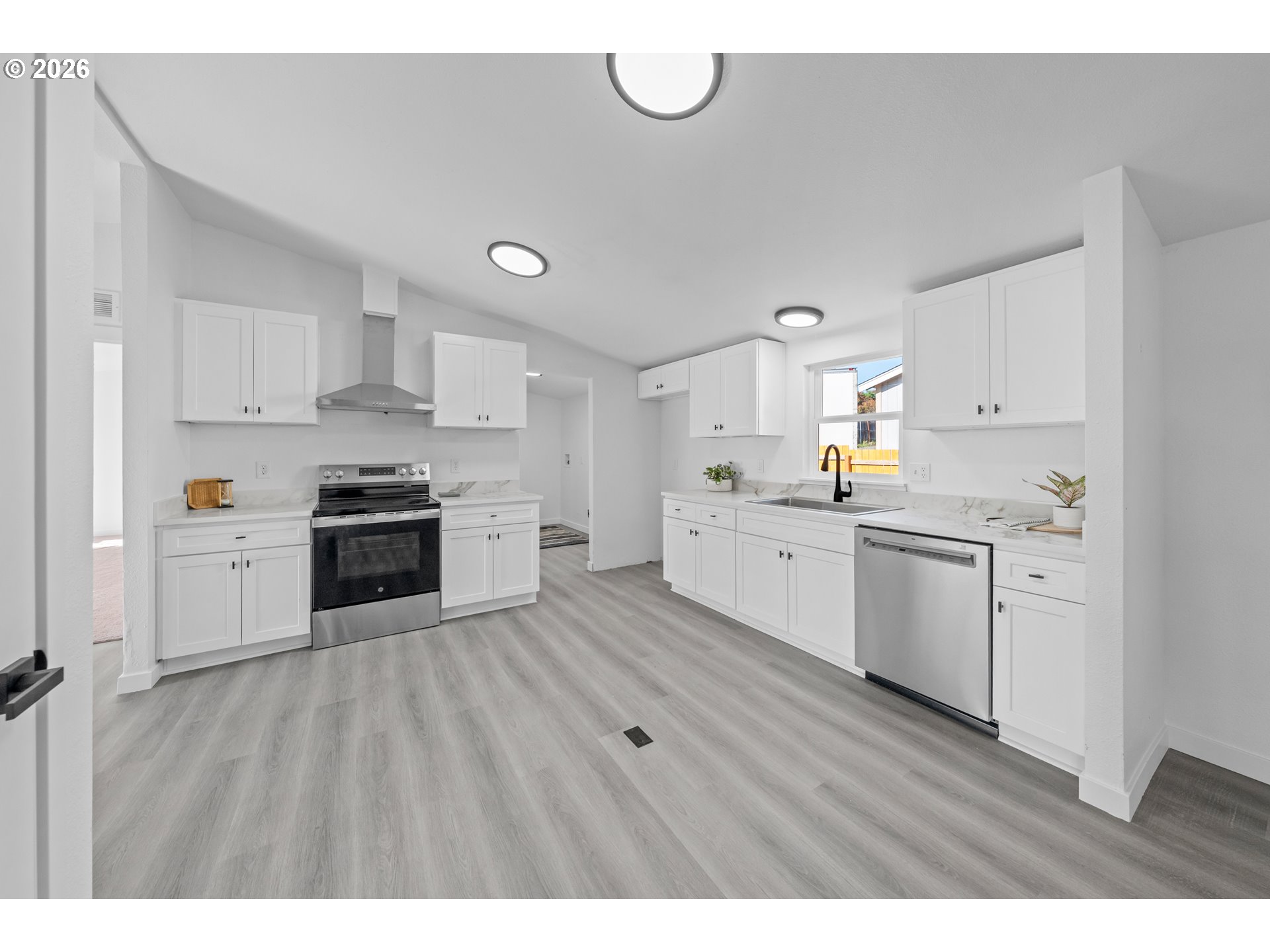 70 Darrell Avenue Winston, OR 97496 - Photo 11 of 39 a kitchen with stainless steel appliances and white cabinets