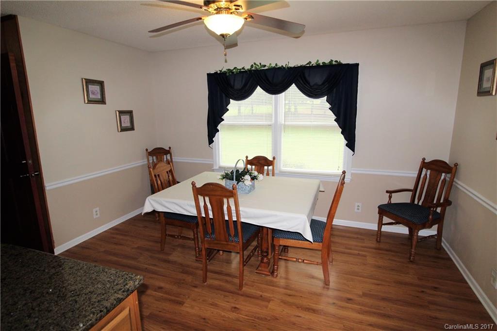 827 Brian Road, Unit 5 Clover, SC 29710 - Photo 4 of 21 a view of a dining room with furniture a chandelier and wooden floor