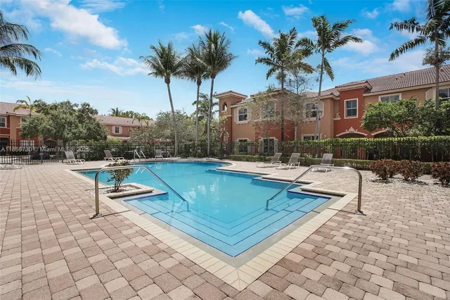 a swimming pool with outdoor seating and a patio