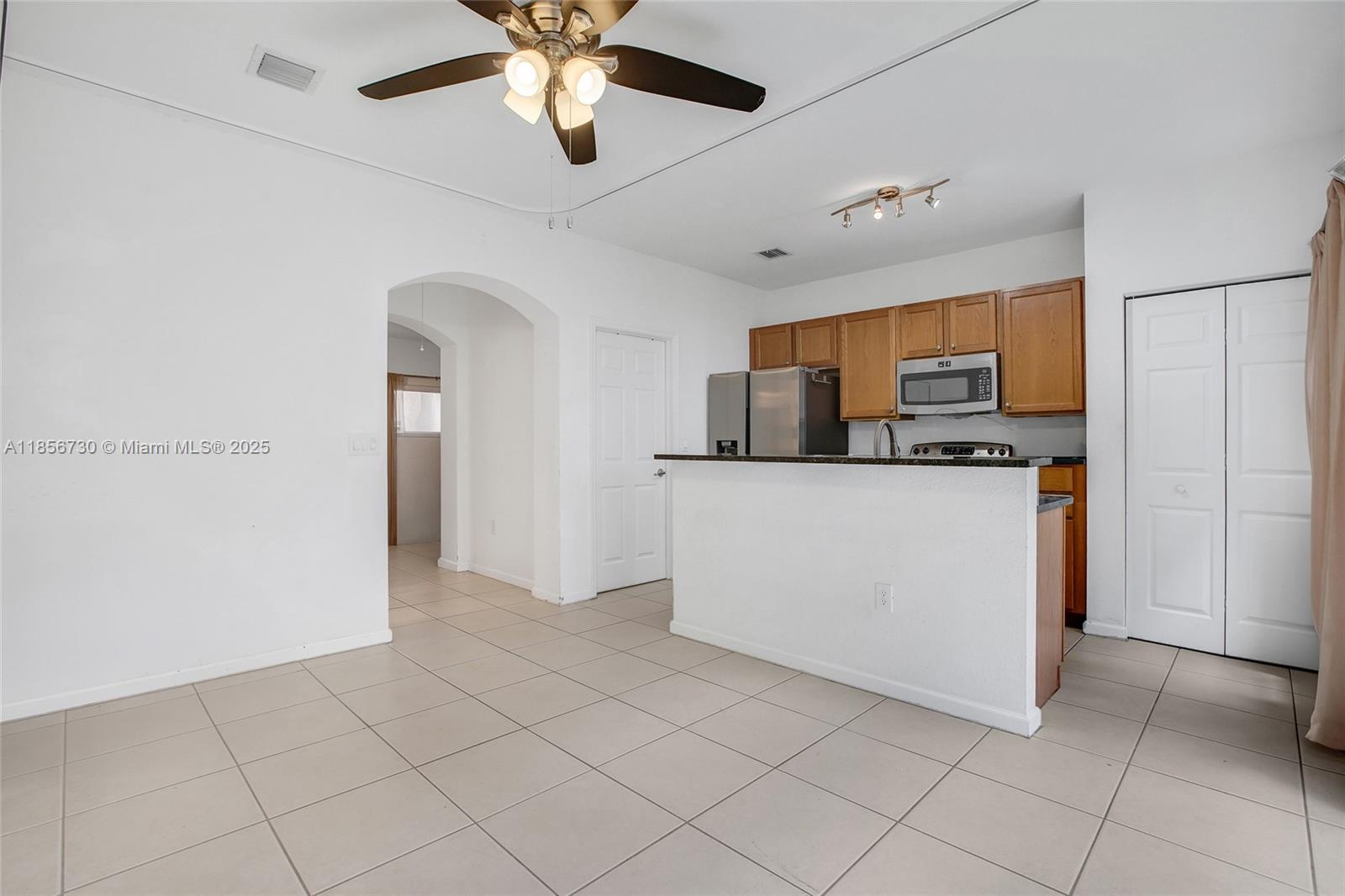 2621 Southwest 120th Terrace, Unit 2032 Miramar, FL 33025 - Photo 16 of 18 a view of kitchen with cabinets and refrigerator