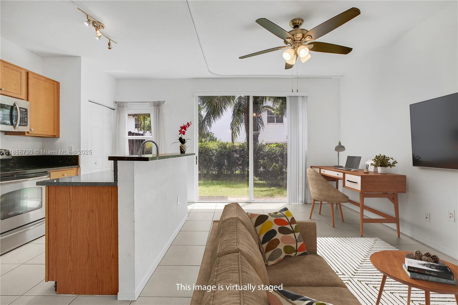 2621 Southwest 120th Terrace, Unit 2032 Miramar, FL 33025 - Photo 5 of 18 a living room with furniture and a flat screen tv
