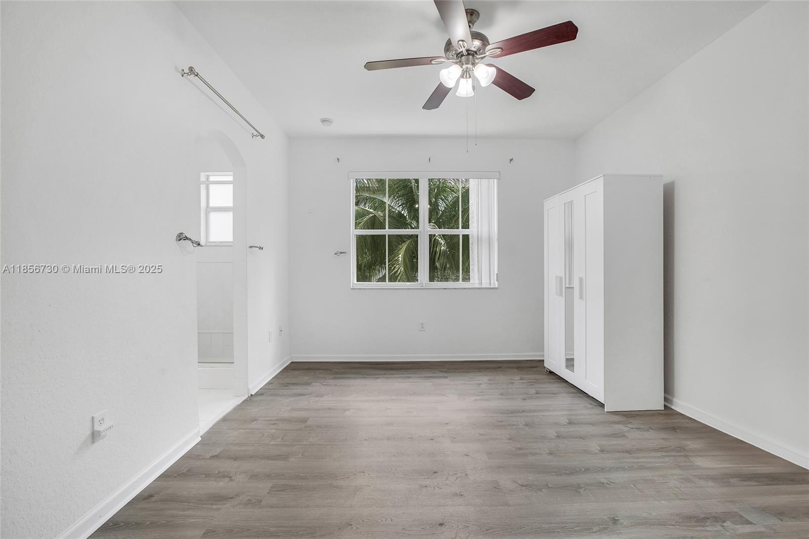 2621 Southwest 120th Terrace, Unit 2032 Miramar, FL 33025 - Photo 6 of 18 wooden floor in an empty room with a window