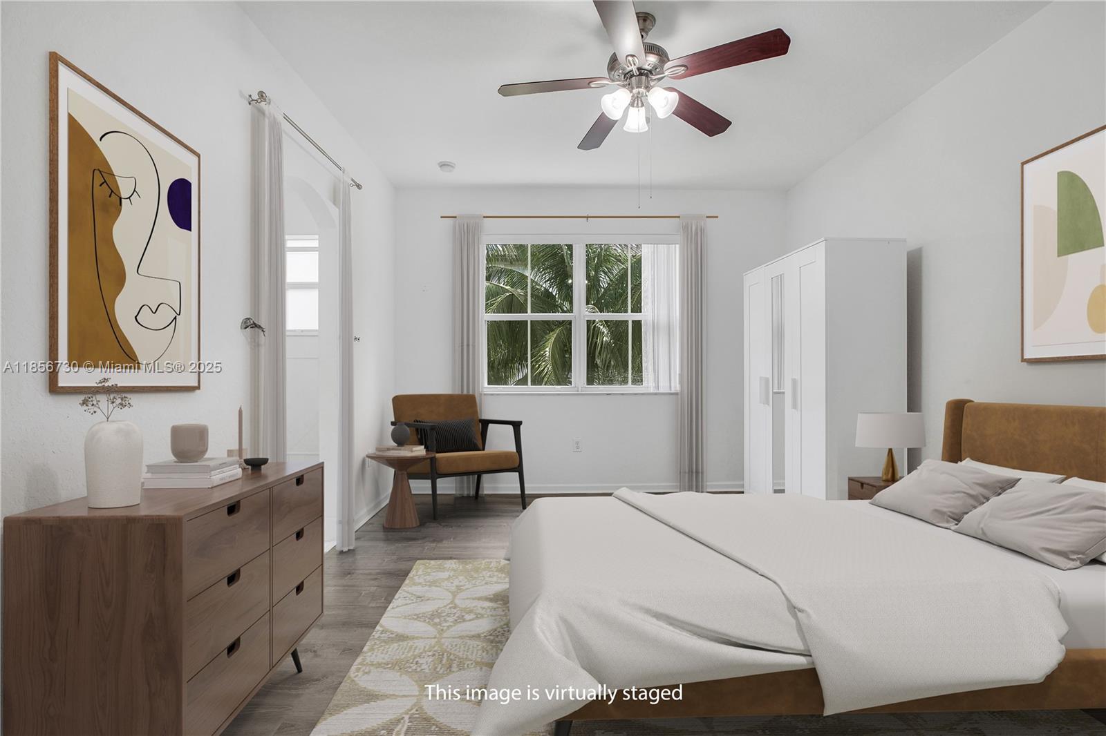 2621 Southwest 120th Terrace, Unit 2032 Miramar, FL 33025 - Photo 7 of 18 a bedroom with a large bed and a chandelier