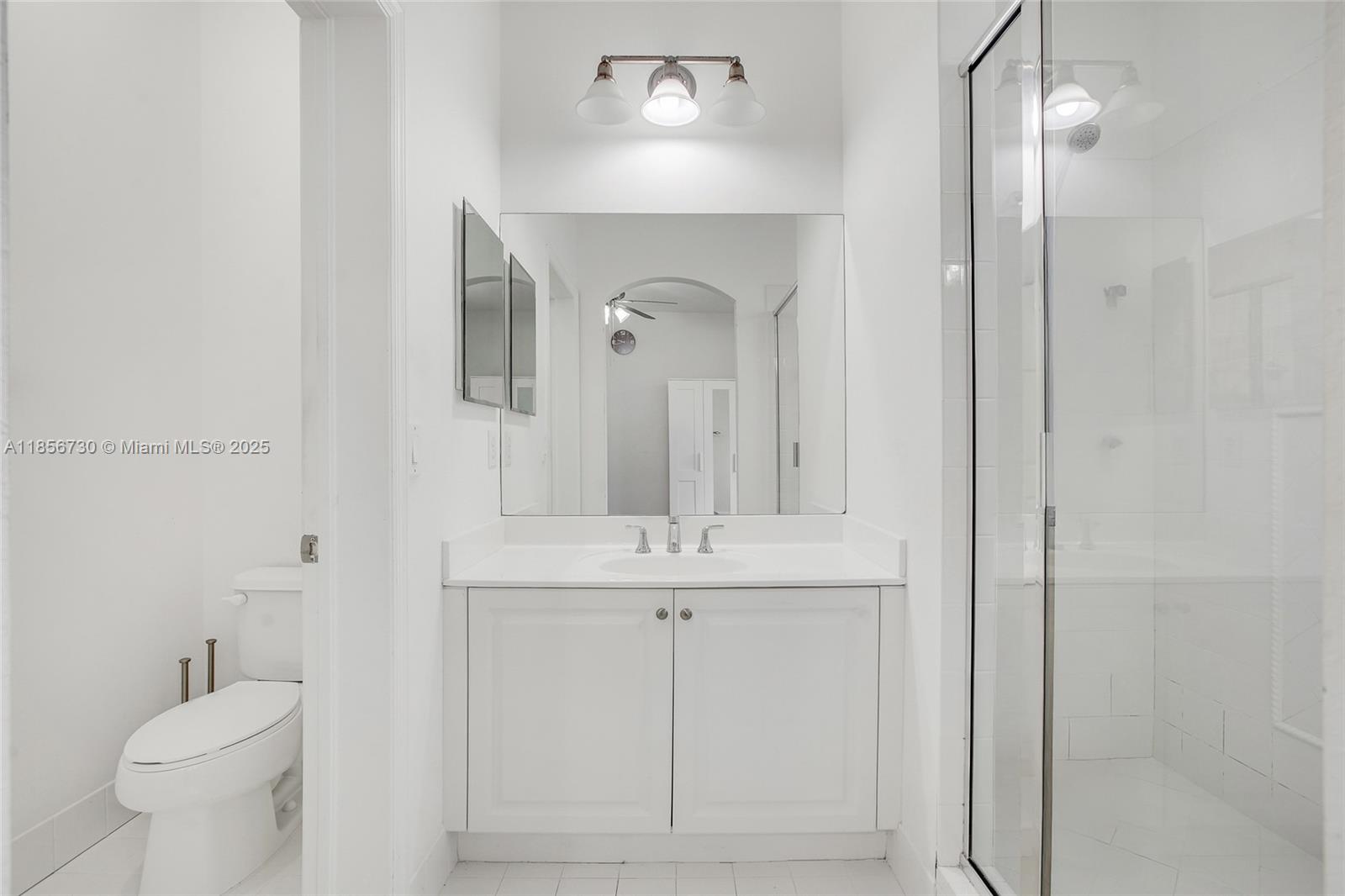 2621 Southwest 120th Terrace, Unit 2032 Miramar, FL 33025 - Photo 8 of 18 a bathroom with a sink a toilet and a mirror