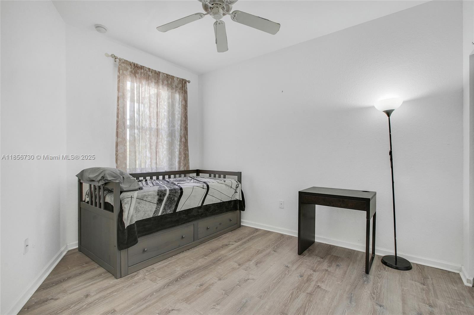 2621 Southwest 120th Terrace, Unit 2032 Miramar, FL 33025 - Photo 9 of 18 a spacious bedroom with a bed and a window