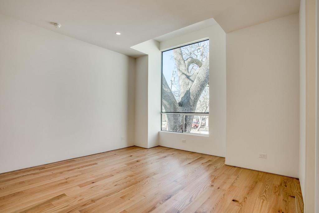 5801 Bryan Parkway Dallas, TX 75206 - Photo 13 of 16 an empty room with wooden floor and a window
