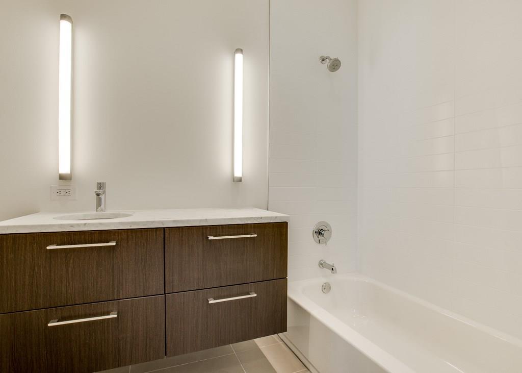 5801 Bryan Parkway Dallas, TX 75206 - Photo 15 of 16 a bathroom with a bathtub and a sink