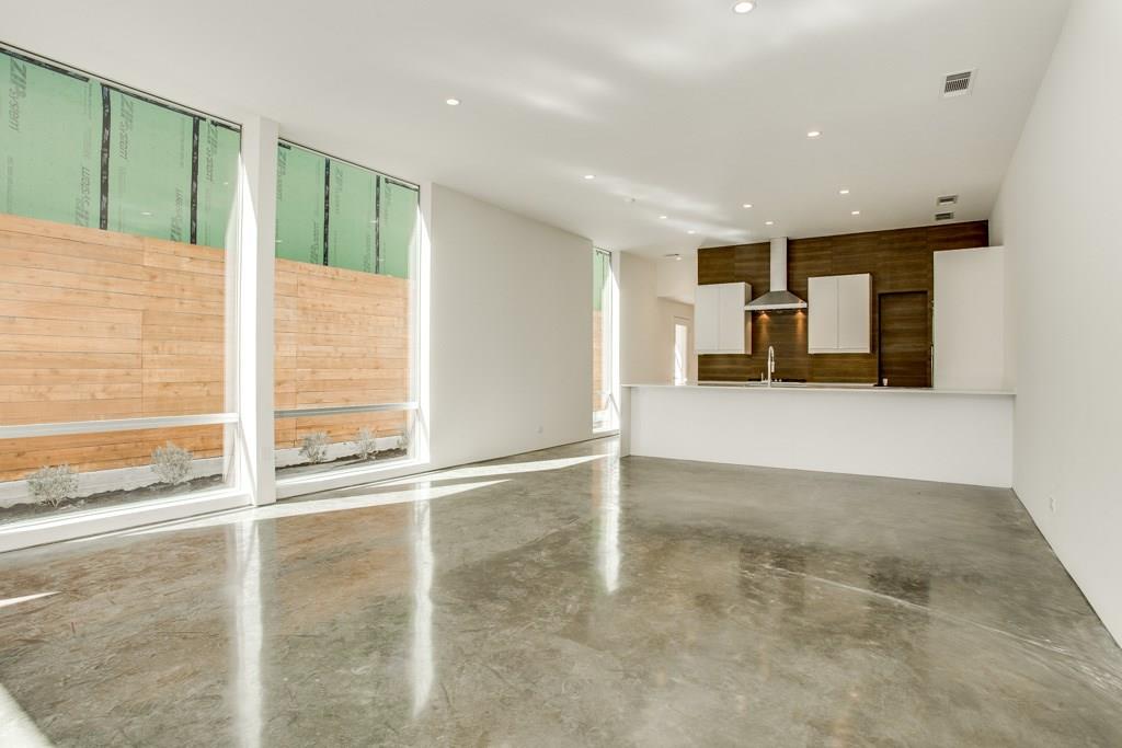 5801 Bryan Parkway Dallas, TX 75206 - Photo 3 of 16 a view of an empty room with a fireplace and a window