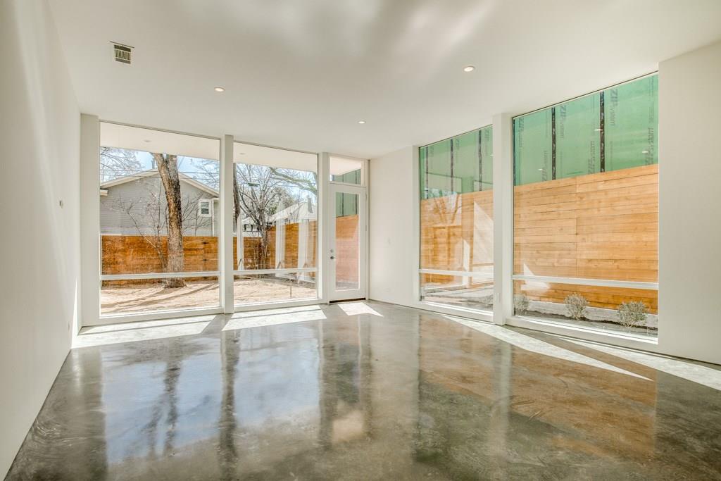 5801 Bryan Parkway Dallas, TX 75206 - Photo 4 of 16 a view of an empty room with a fireplace and a large window