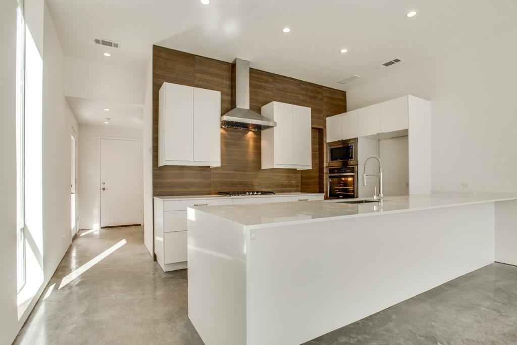 5801 Bryan Parkway Dallas, TX 75206 - Photo 6 of 16 a kitchen with stainless steel appliances kitchen island a stove and a sink