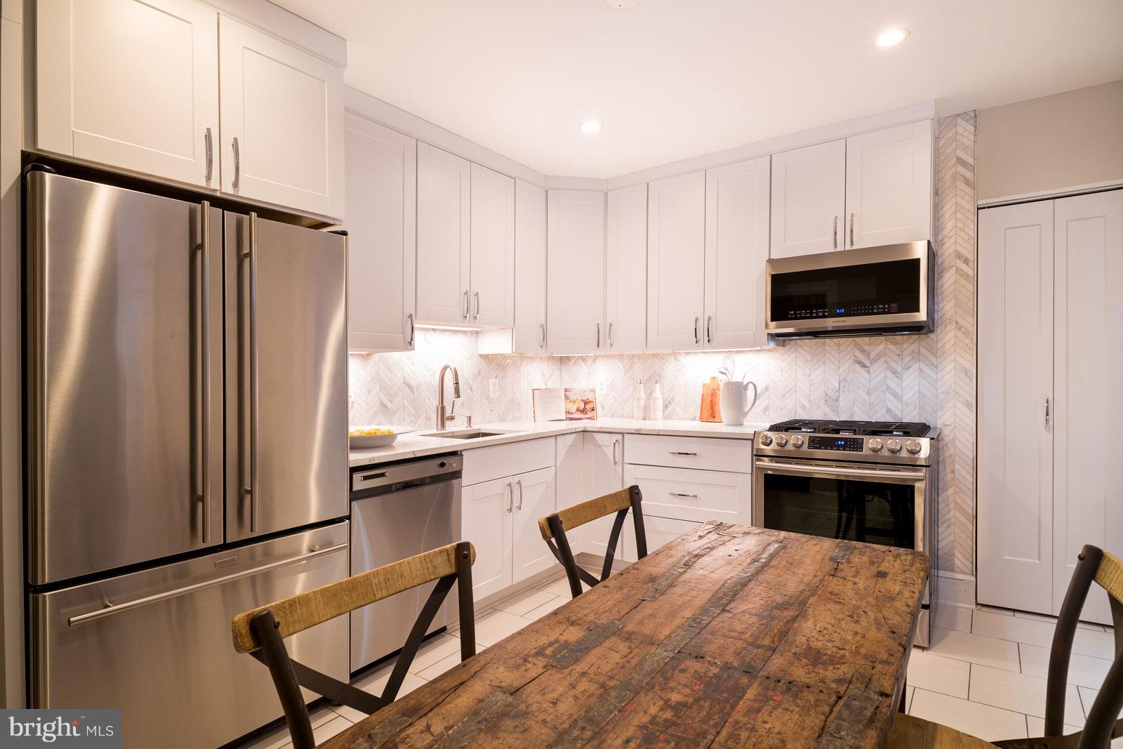 1833 12th Street Northwest Washington, DC 20009 - Photo 14 of 30 a kitchen with a stove a sink and a refrigerator