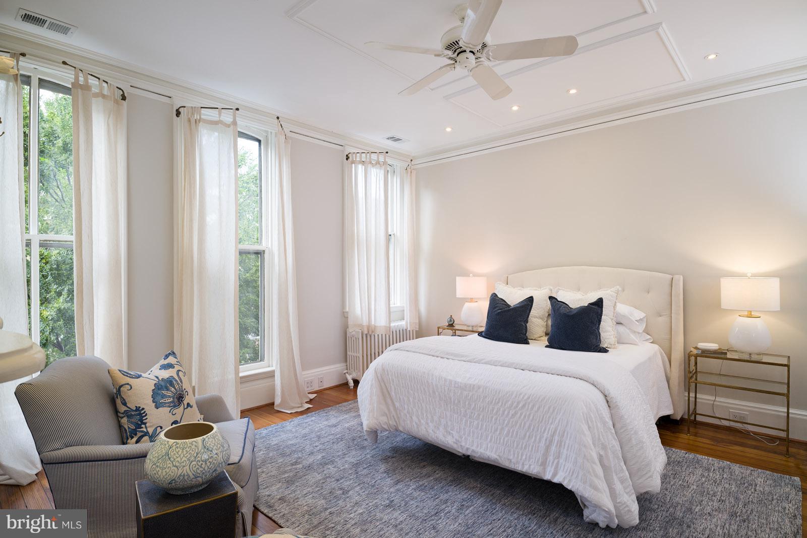 1833 12th Street Northwest Washington, DC 20009 - Photo 18 of 30 a bedroom with a bed and glass window