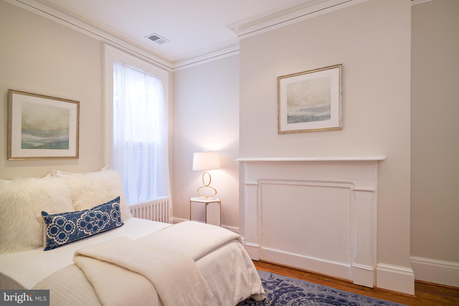 1833 12th Street Northwest Washington, DC 20009 - Photo 19 of 30 a bedroom with a bed and a window