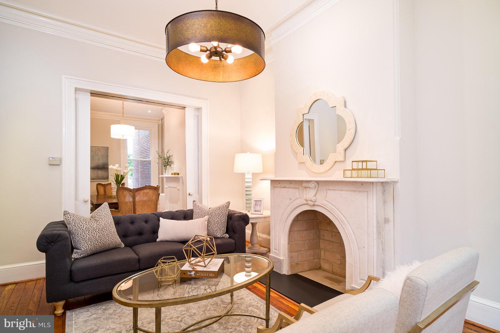 1833 12th Street Northwest Washington, DC 20009 - Photo 6 of 30 a living room with furniture a fireplace and a chandelier