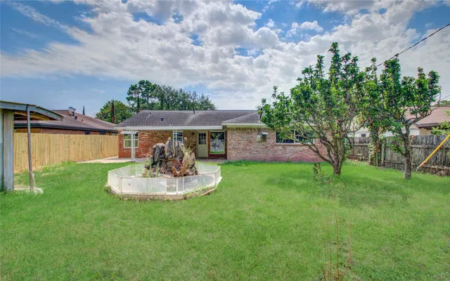 a front view of a house with a yard and trees