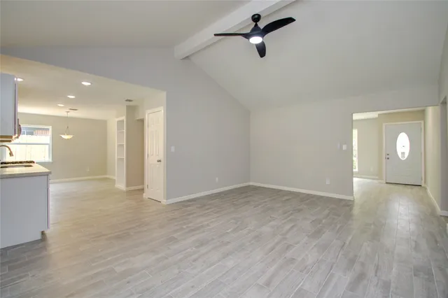 a view of a room with wooden floor and window