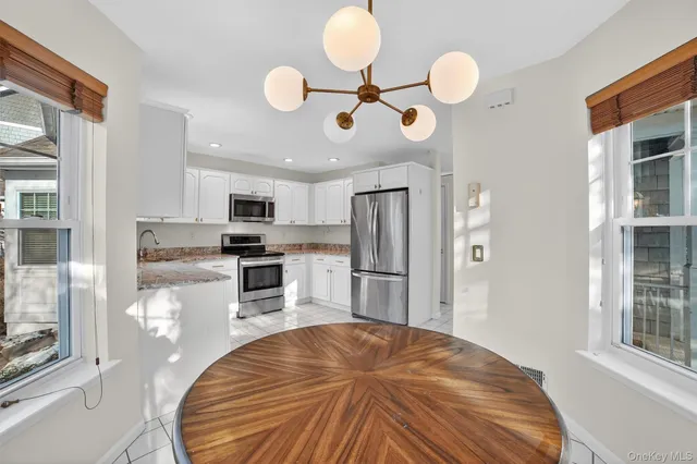 a view of a hallway to rooms and dining room