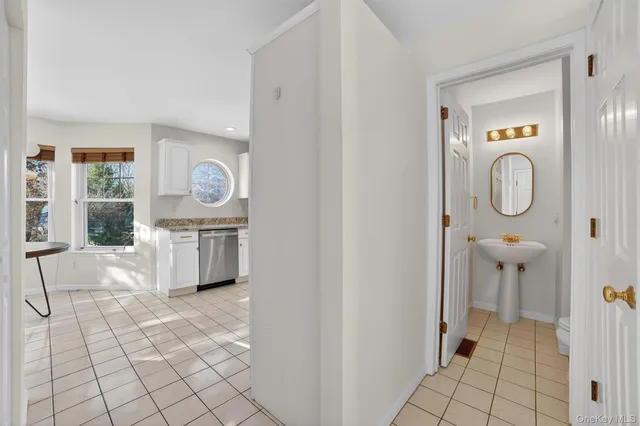 an empty room with closet and a hallway