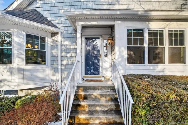 a view of empty room with wooden floor and fireplace