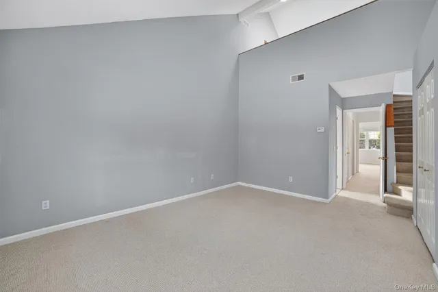 a view of an empty room with a ceiling fan