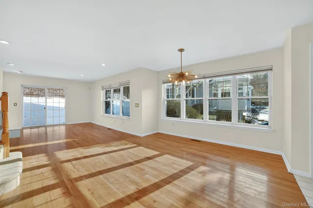 a view of a livingroom with wooden floor and a fireplace
