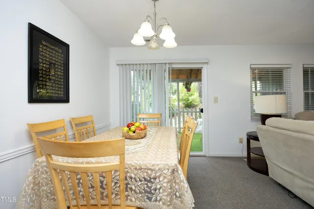 a view of a dining room with furniture wooden floor and chandelier