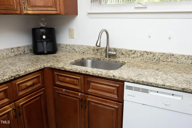 a kitchen with stainless steel appliances granite countertop a sink stove and microwave