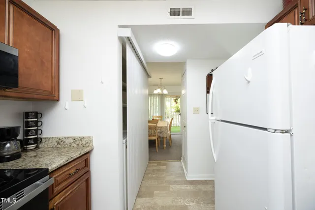 a kitchen with granite countertop a sink and cabinets