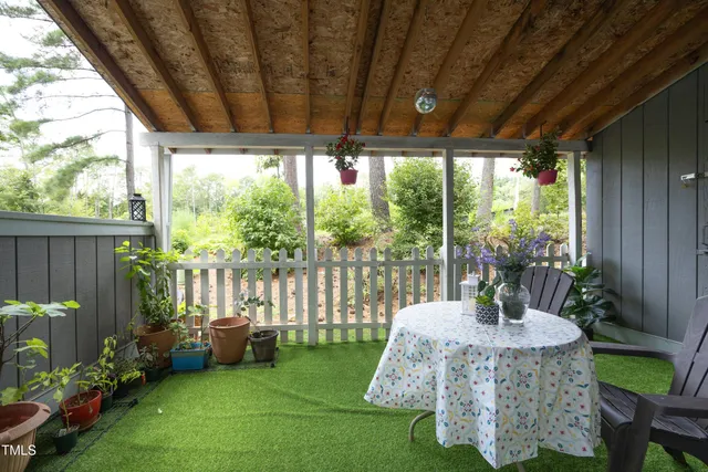 a view of a patio with a table chairs and a backyard