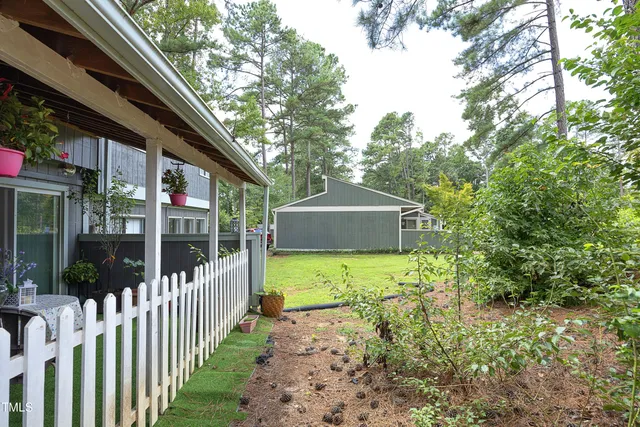 a view of a patio with a table chairs and a backyard