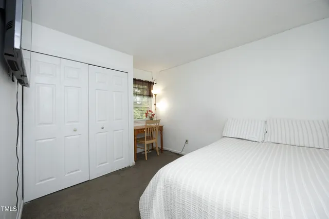 a bedroom with a bed and a mirror