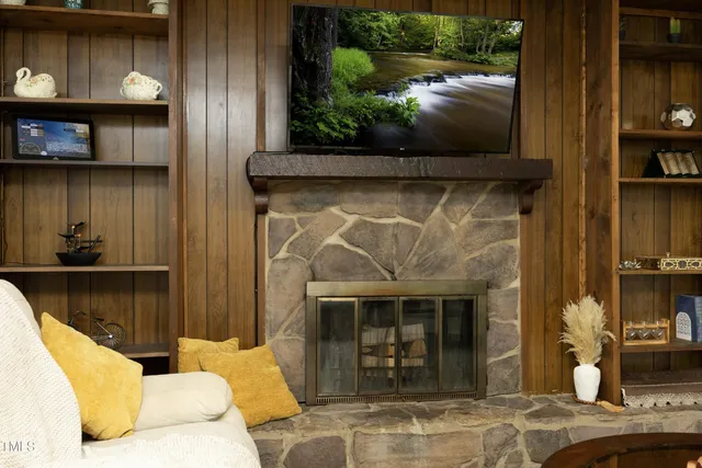 a living room with furniture a fireplace and a flat screen tv