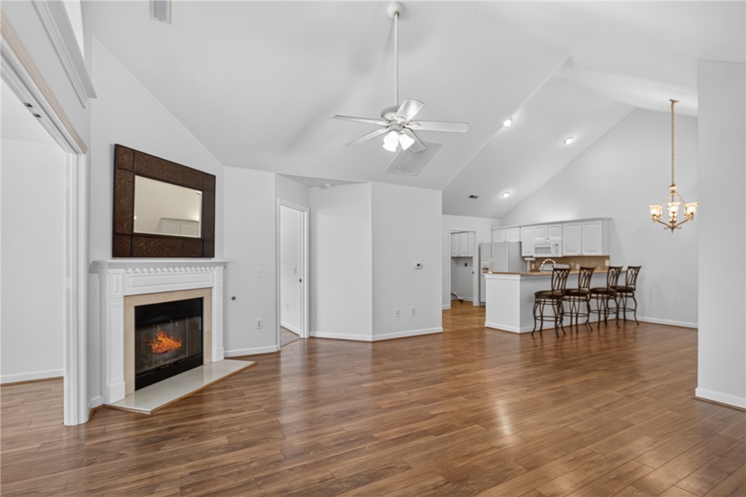 134 Life Style Lane Anderson, SC 29621 - Photo 7 of 44 Hardwood flooring extends throughout this expansive living space, offering a captivating fireplace.
