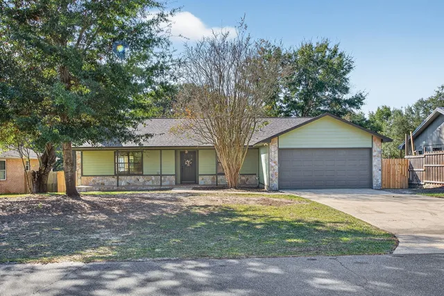 a front view of house with yard and trees