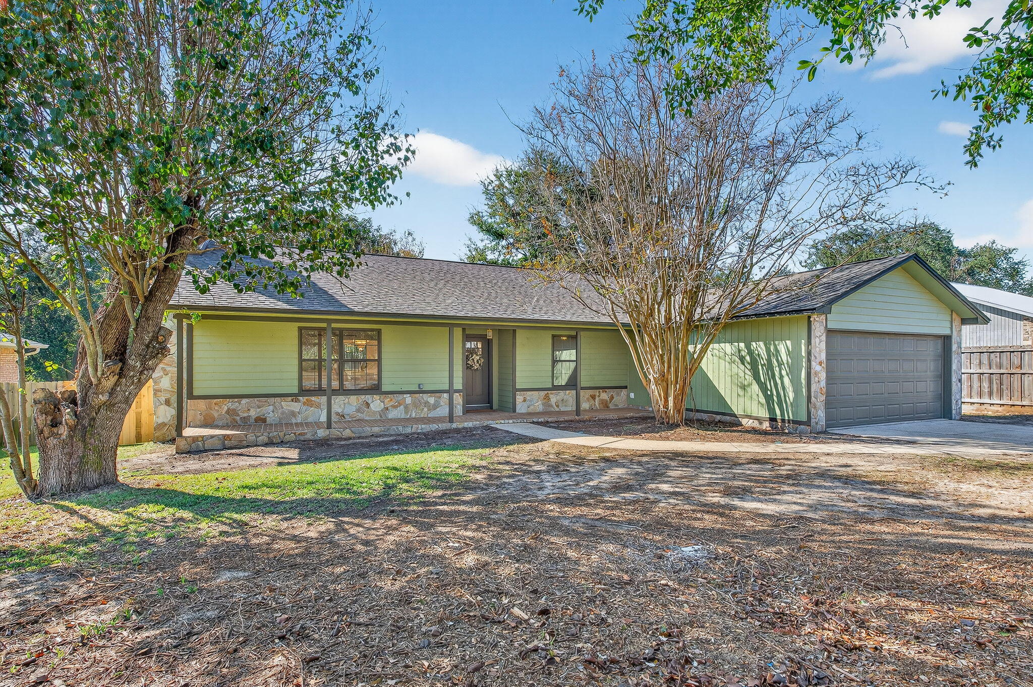 932 Ridgewood Way Niceville, FL 32578 - Photo 2 of 47 a view of a yard with a house and a large tree