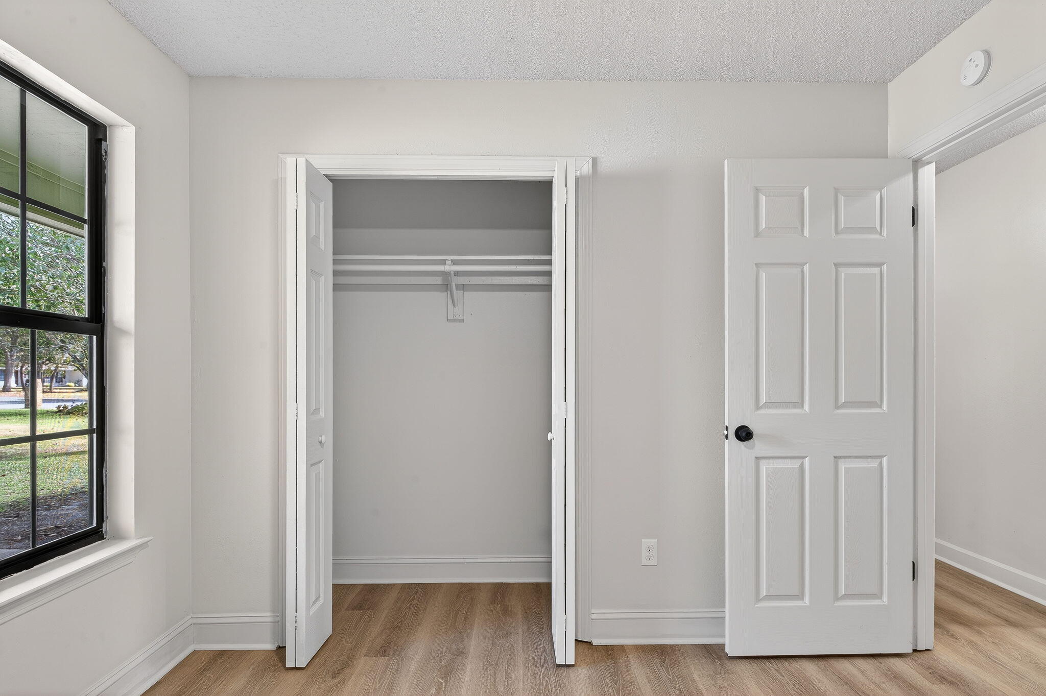 932 Ridgewood Way Niceville, FL 32578 - Photo 25 of 47 an empty room with wooden floor cabinet and windows