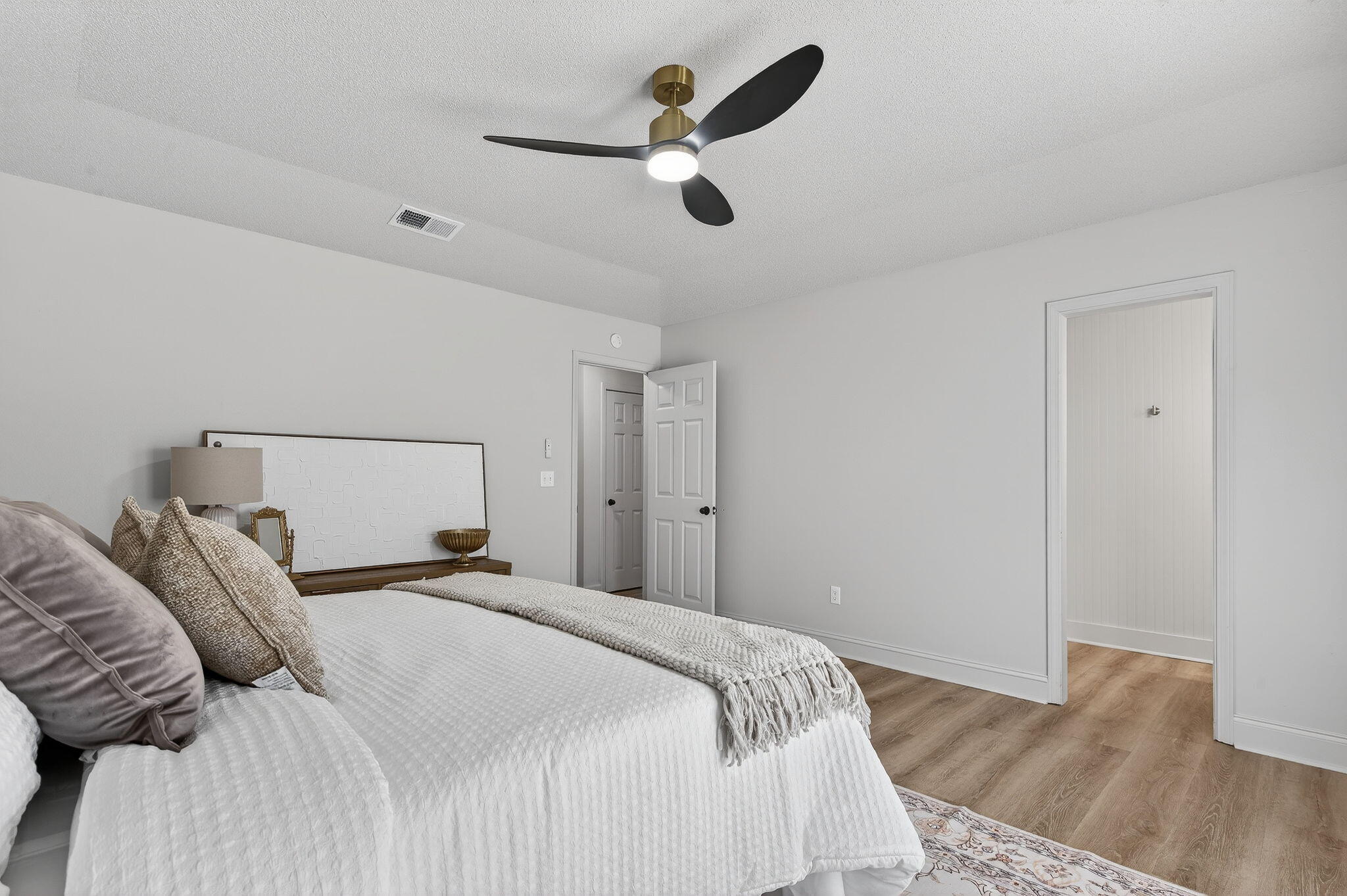 932 Ridgewood Way Niceville, FL 32578 - Photo 28 of 47 a bedroom with a bed and a chandelier